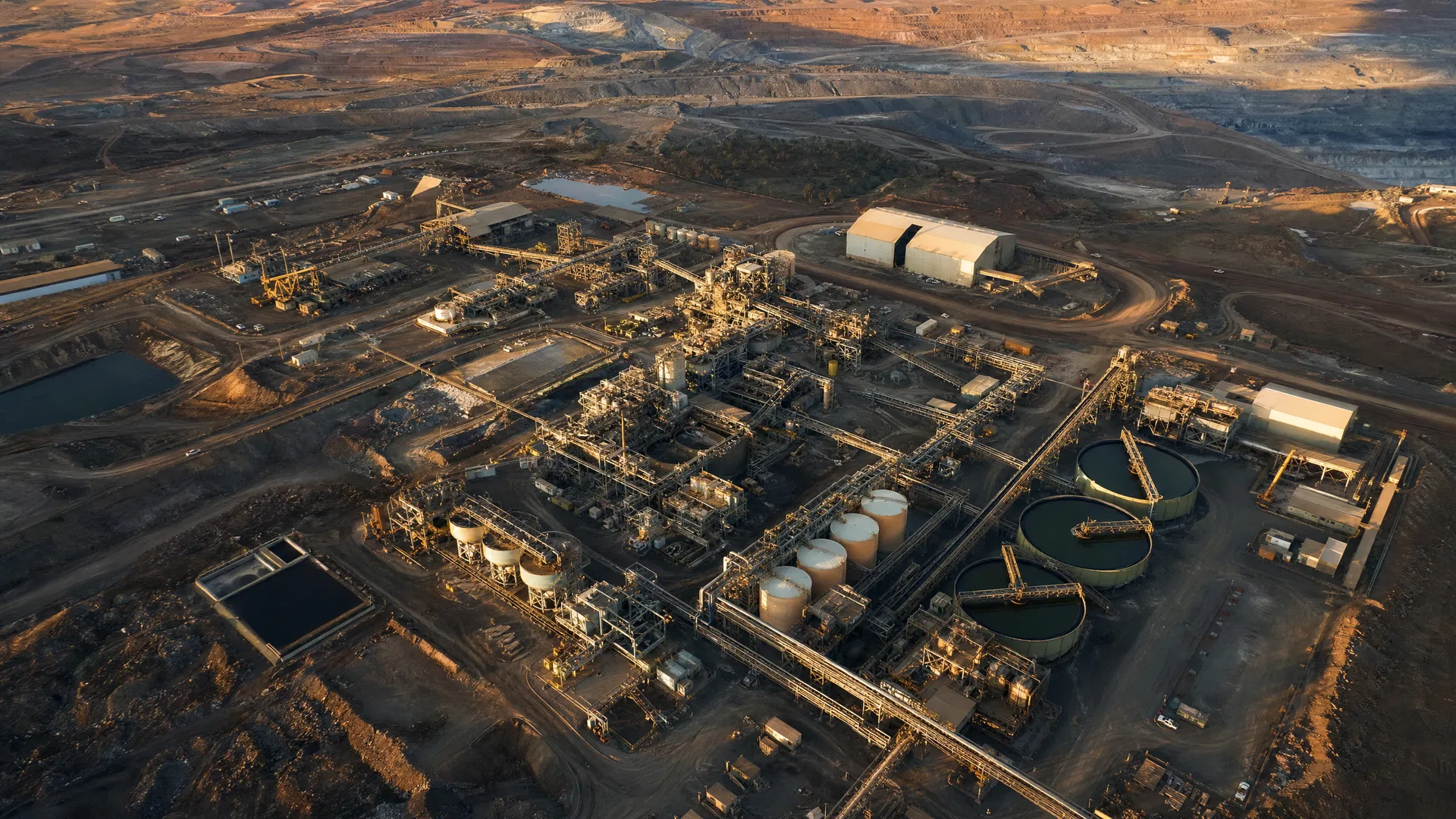 Remote mine processing plant and industrial infrastructure beside an open pit
